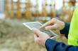 © pressmaster - Hand of engineer pointing at sketch of building on screen of tablet
