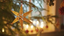 CHRISTMAS DECORATIONS - Straw Star Hanging On A Christmas Tree, Sweden, Close Up