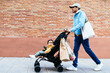 © BONNINSTUDIO/Stocksy - Indian father with baby walking near brick wall after shopping