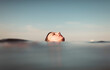 © Ibai Acevedo/Stocksy - Girl face floating in the sea