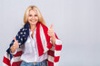 © denis_vermenko - Smiling senior beautiful patriotic woman wearing united states flag isolated over white background with a surprise face.