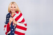 © denis_vermenko - Smiling senior beautiful patriotic woman wearing united states flag isolated over white background with a surprise face.