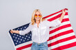 © denis_vermenko - Smiling senior beautiful patriotic woman wearing united states flag isolated over white background with a surprise face.