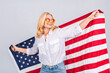 © denis_vermenko - Smiling senior beautiful patriotic woman wearing united states flag isolated over white background with a surprise face.