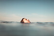© Ibai Acevedo/Stocksy - Side view of a floating head in the sea