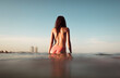 © Ibai Acevedo/Stocksy - Girl standing in the water looking at Barcelona