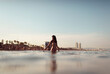 © Ibai Acevedo/Stocksy - Girl entering into the waters of Barcelona beach