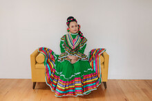 Portrait Of A Mexican-American Tween Girl Dressed Up With A Jalisco Folkloric Dress