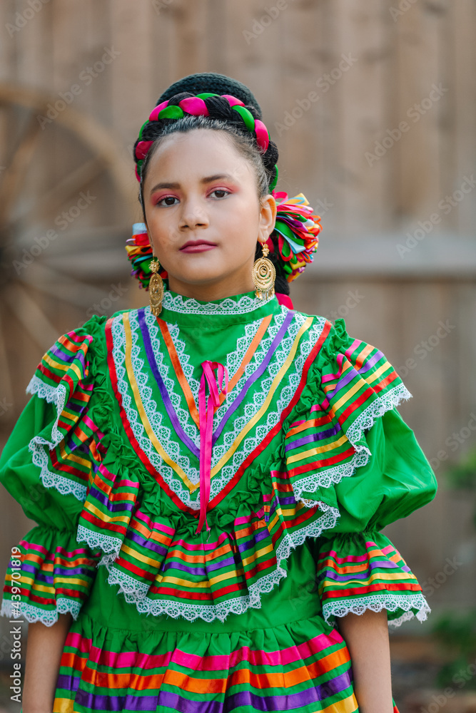Portrait Of A Mexican American Girl Dressed Up With A Traditional 