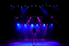 Unrecognizable Singer Standing On Stage At Microphone, Back View, Neon Lights
