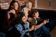 © alfa27 - people enjoying of playing in video game, rest at home. friends have fun during game , excited millennial diverse american friends have fun with joysticks in living room interior