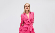 Blond Stylish Female In Pink Suit .