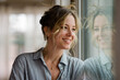© McKinsey Jordan/Stocksy - Beautiful Woman Smiles While Looking Out a Window