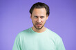 © kohanova1991 - Angry stressed man isolated over purple background. Depressed guy looking to camera with aggression.