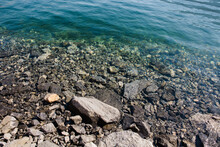 Shoreline Of Water And Rocks On Lake