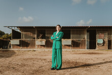 Fashionable Woman In A Green Suit In A Barn