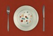 © Valeriya Simantovskaya/Stocksy - Variety of pills on plate with knife and fork