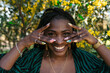 © Lucas Ottone/Stocksy - Happy black woman with cool manicure
