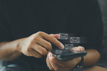Poster - Businessman hands sending or reading email marketing by digital smartphone,.communication connection message to global letters in the workplace.