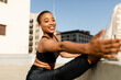 © McKinsey Jordan/Stocksy - Beautiful Black Woman Reaches For Her Foot While Stretching Her Leg