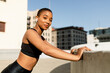 © McKinsey Jordan/Stocksy - Beautiful Black Woman Begins Her Rooftop Workout