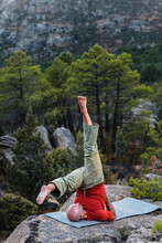 Middle Aged Man Doing Shoulder Stand In Mountains 