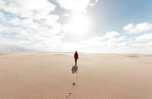 Woman Walking At The Desert With A Camera