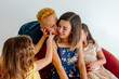 © Erin Brant/Stocksy - Girl encourages two moms to kiss