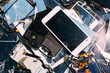 © Alexandra Bergam/Stocksy - Broken tablet and phone screens on a pile.
