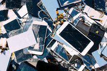 Broken Tablet And Cell Phone Screens On A Pile.