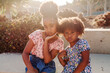 © Erin Brant/Stocksy - Young Black sisters pose for photo