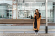 © Ivan Ozerov/Stocksy - Young female using smartphone on bus stop