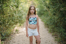 Portrait Of A Young Girl In A Swim Top And Shorts