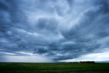 Storm Clouds Over A Farmer's Field On The Prairies.