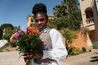 © Lucas Ottone/Stocksy - Woman holding a flower bouquet