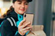 © Studio Firma/Stocksy - Delivery Woman Using Phone