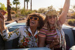 © Raymond Forbes Photography/Stocksy - Two girls riding in back of Convertible car