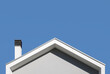 © Marco Reggi/Stocksy - pitched roof with chimney