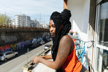 Black Girl With Dreadlocks Hair Looking From The Balcony 