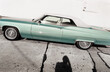 © James Ross/Stocksy - Convertible car in the street