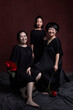 © ChaoShu Li/Stocksy - Portrait shot of Asian female sisters, wearing black skirts indoors.