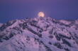 © plpictures by Paedii Luchs/Stocksy - Full moon rising on winter landscape