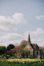 A Church With Daffodils In The Foreground