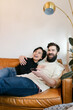 © Leah Flores/Stocksy - Laughing Couple Watching Comedy