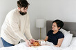 © Leah Flores/Stocksy - Woman Receiving Breakfast in Bed