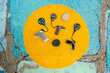 © Erin Brant/Stocksy - Cochlear implants in painted yellow circle