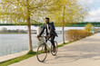© Mihajlo Ckovric/Stocksy - Young african american businessman riding a bicycle to work in the urban city zone