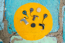 Cochlear Implants In Painted Yellow Circle