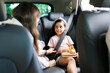 © AntonioDiaz - Young woman talking with their children in the car