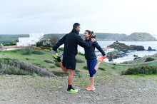 Smiling Couple Stretching Before A Scenic Run